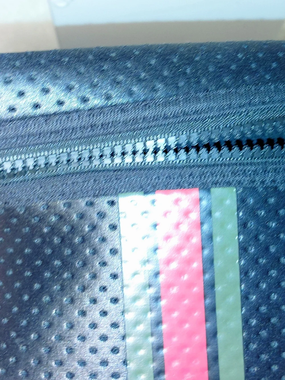 New perforated black leatherBlack Perforated Zip Pouch with Green and Red Stripe
